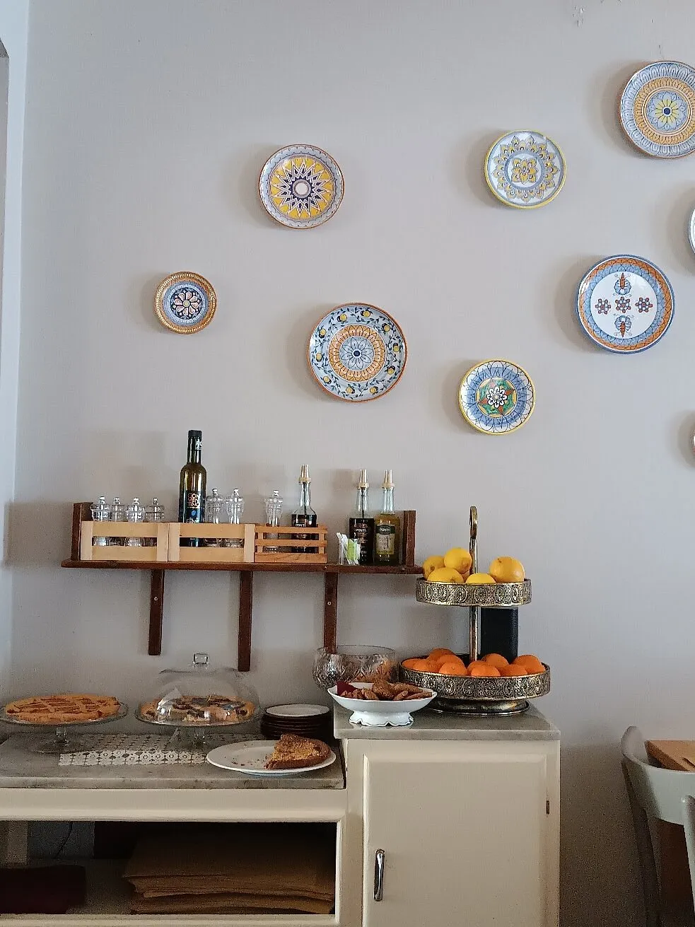 Piatti in ceramica dipinti alle pareti della sala, accanto al bancone dei dolci Piatti in ceramica dipinti alle pareti della sala, accanto al bancone dei dolci
