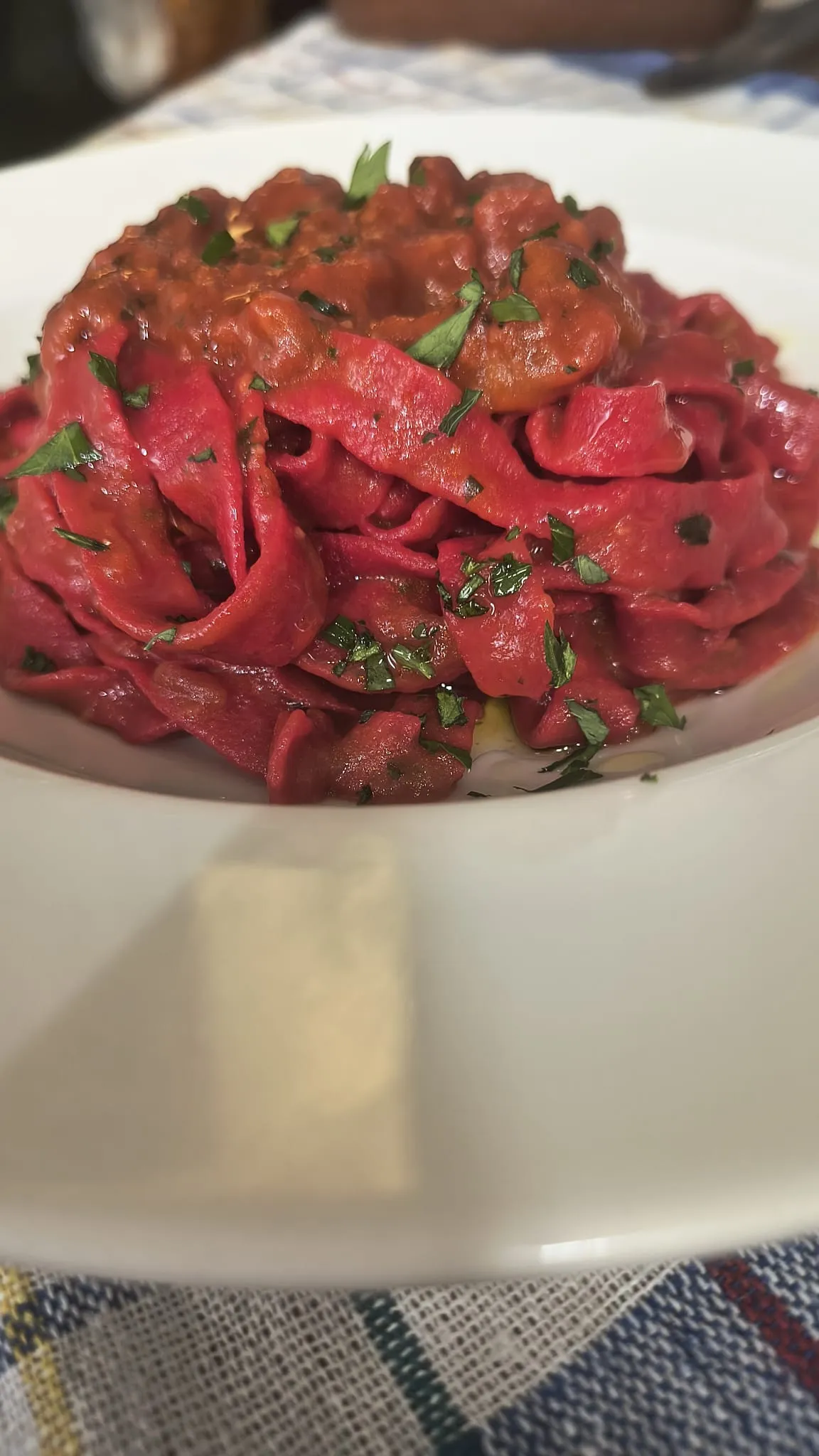 Tagliatelle rosse al ragù in un piatto bianco Tagliatelle rosse al ragù in un piatto bianco